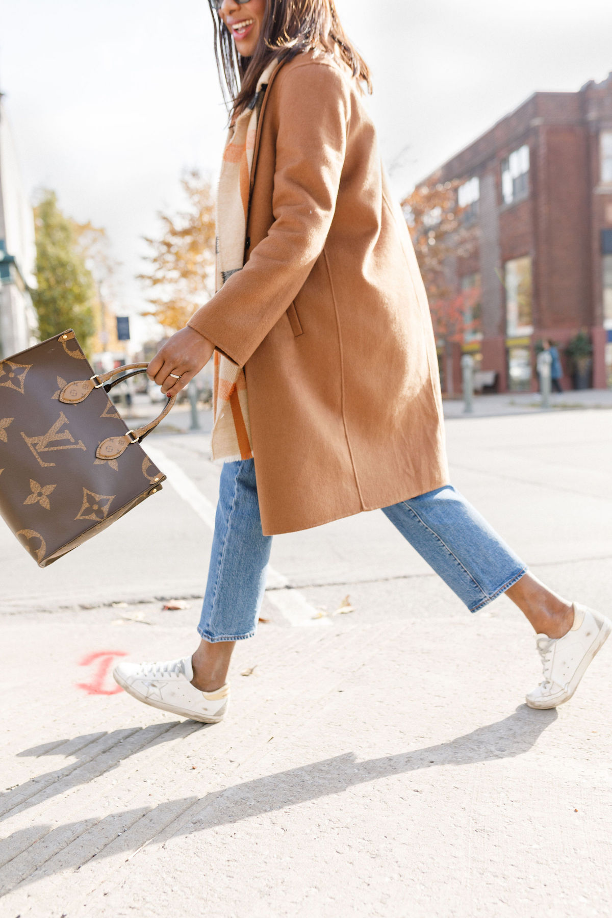 Sharifa Samora golden goose sneakers and Louis Vuitton on the go